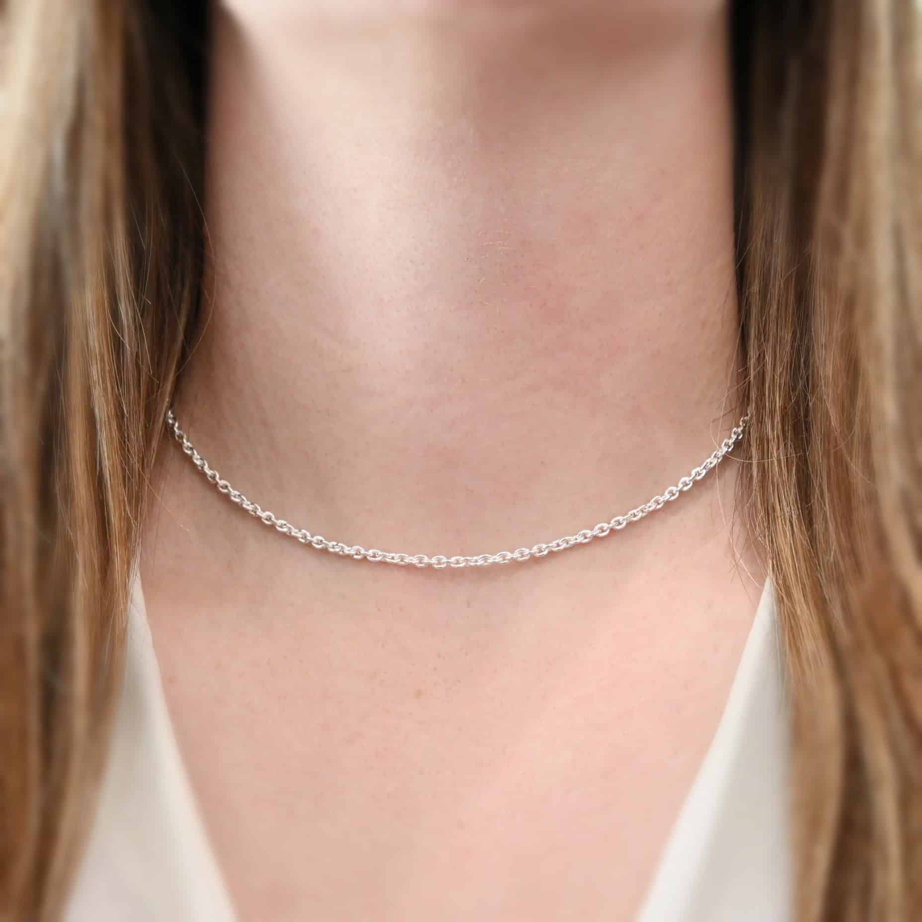 Maria Chain, 16", Shiny Close up of the "Maria" Chain as shown on a model. Chain is shown at 16" long and shiny. Model is wearing a white v-neck shirt. Links are 4x3mmx.8mm thick.
