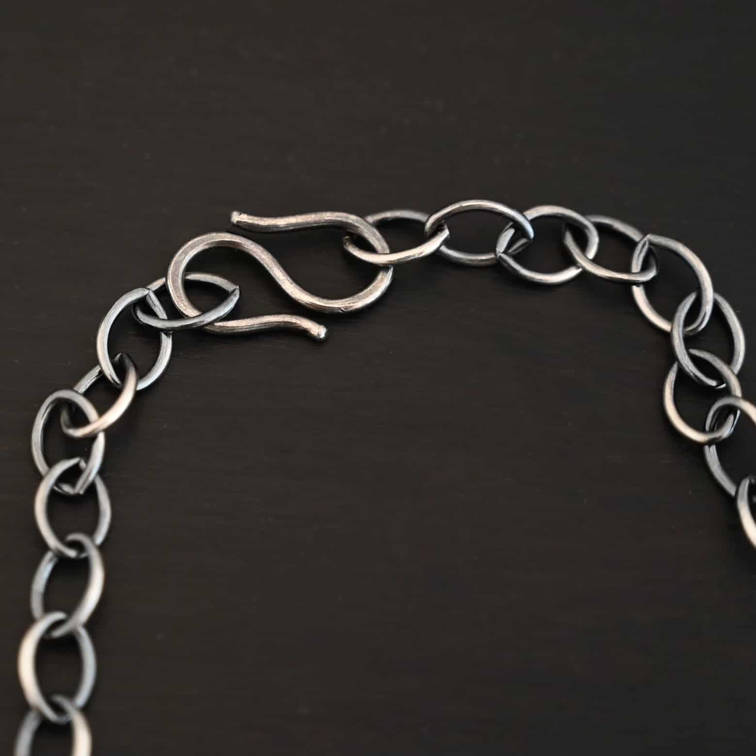 Sky Chain, Oxidized, Smooth Close up of the oxidized sterling silver Sky Chain that is made with large oval links that are smooth and connected together and there is an emphasis on the chain