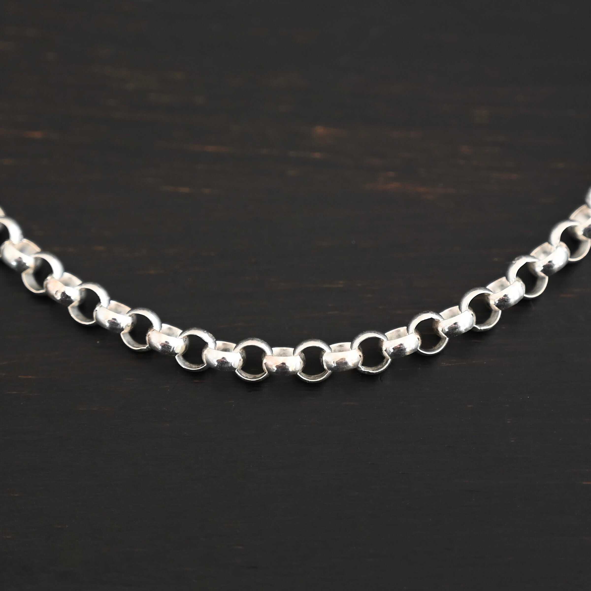 Close up of the shiny sterling silver Roxy Rolo Chain that is made with small circular links all connected together