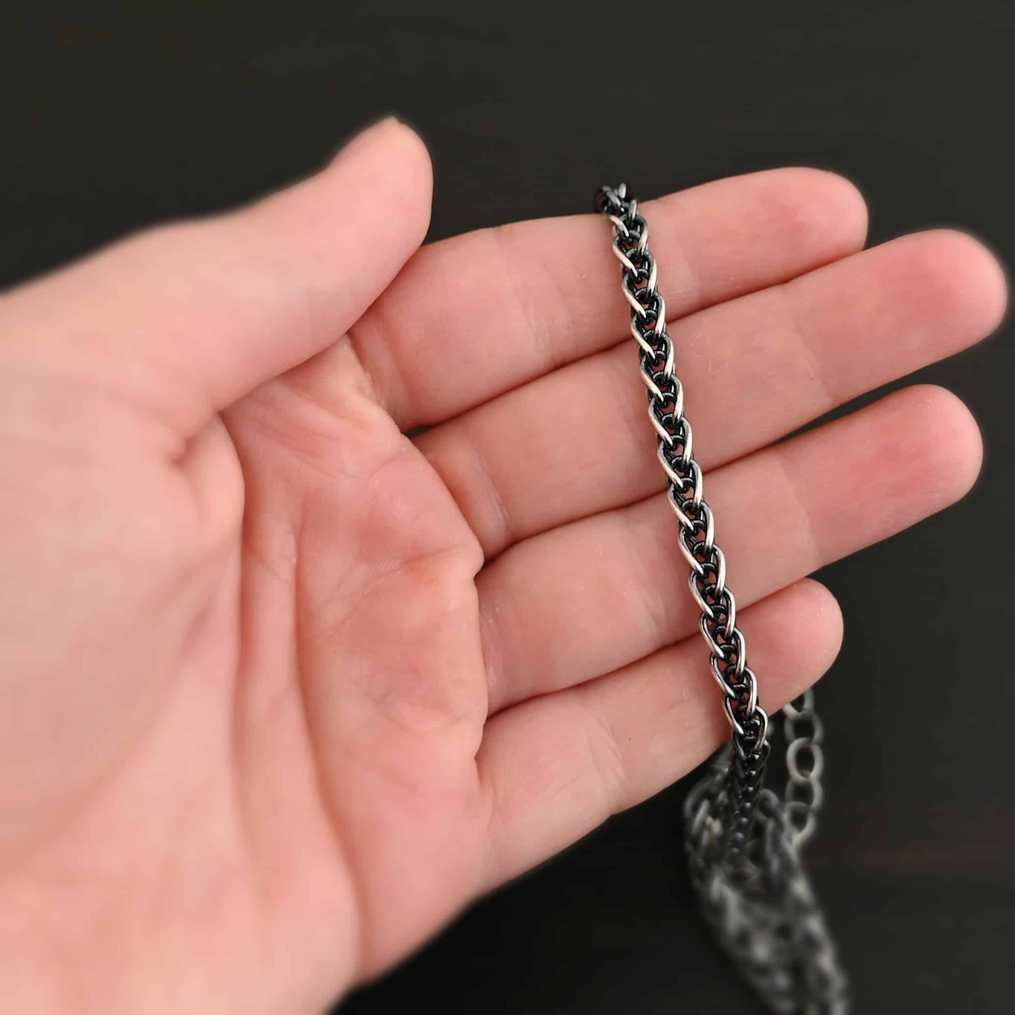 King Cobra Wheat Chain The "King Cobra" Wheat Chain. Chain is handmade out of sterling silver and woven together loosely. Each link is woven to another one and there are sterling silver end caps on each end of the chain. Chain has a lobster claw clasp and comes with a 3 inch extension. Chain is laying on the fingers of a hand, and is shown as oxidized.