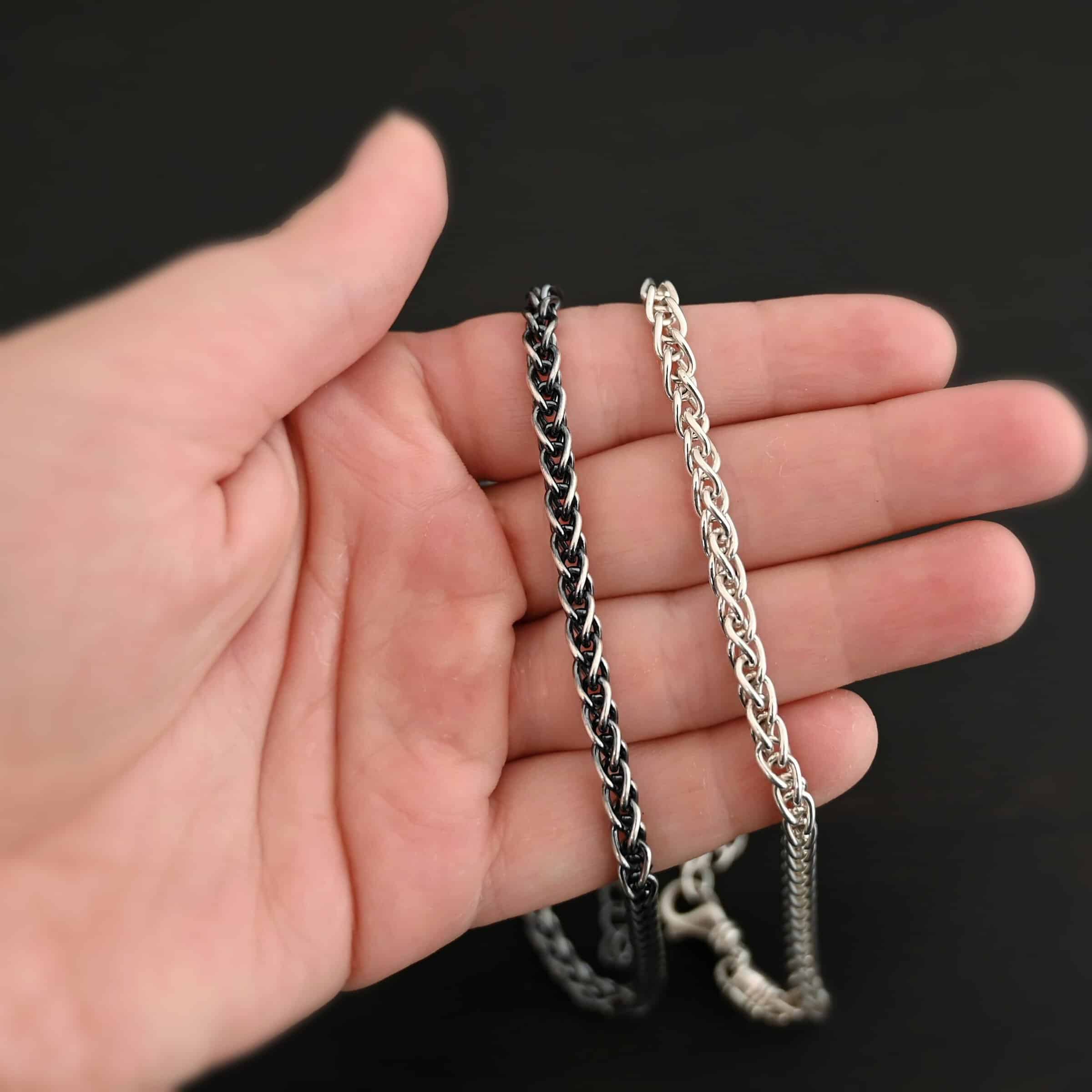 King Cobra Wheat Chain The "King Cobra" Wheat Chain. Chain is handmade out of sterling silver and woven together loosely. Each link is woven to another one and there are sterling silver end caps on each end of the chain. Chain has a lobster claw clasp and comes with a 3 inch extension. Chain is laying on the fingers of a hand, and is shown as both shiny and oxidized.