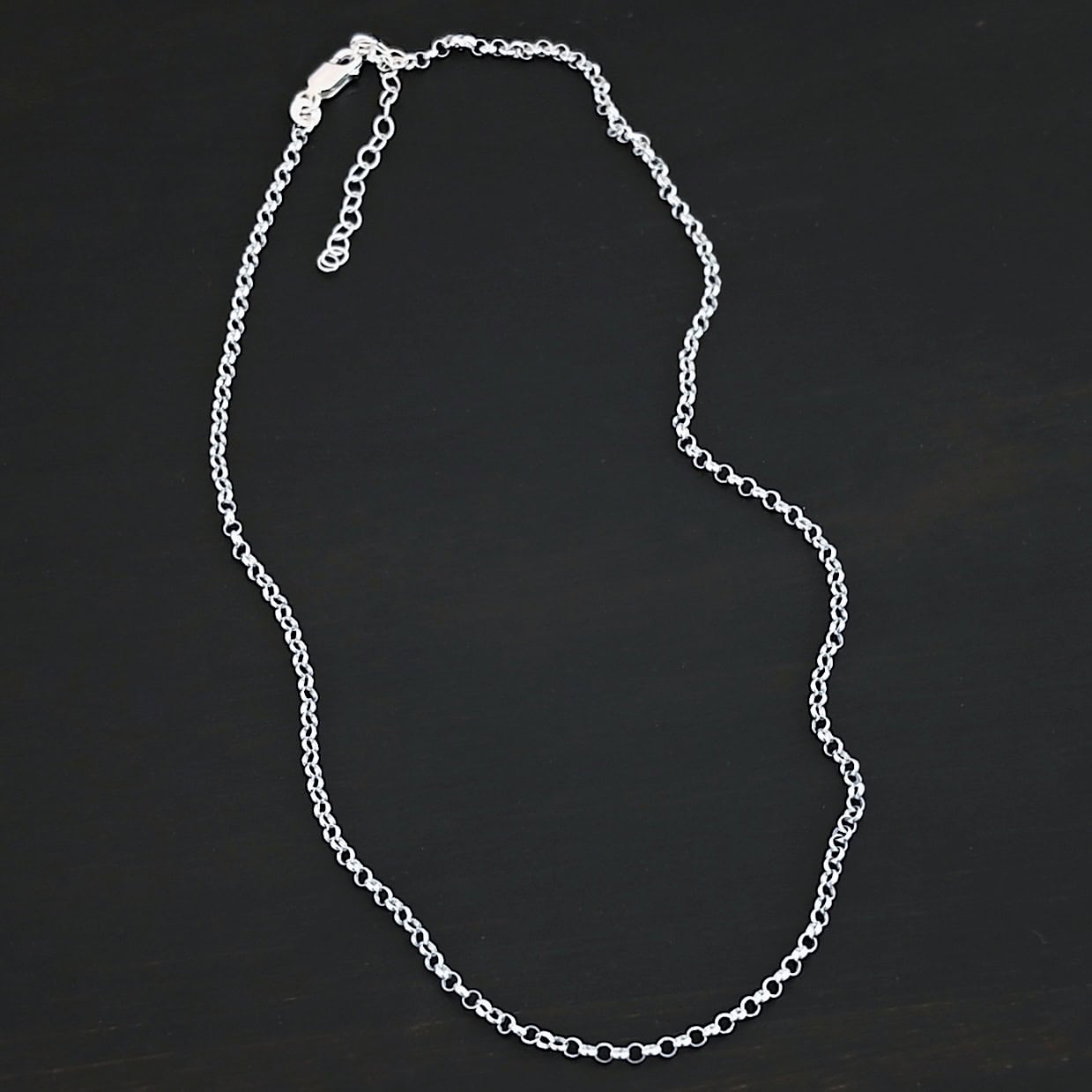 "Rachel Rolo" Chain as shiny. Made out of sterling silver and comes with the 3 inch chain extension. Chain is made out of small, but thick circles. Chain has a lobster claw clasp.