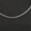 Close up of an oxidized sterling silver Joan chain with oval links that is resting against a dark background. Links are 6x5mmx1.2mm thick.