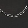 A close-up of the oxidized sterling silver Jay chain set against a dark black background. Links measure 7.2×5.7mm.
