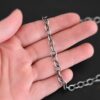 Oxidized sterling silver Jay chain with circular links that measure 7.2×5.7mm lying on a hand that is resting against a dark background.