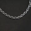 Close up of Georgia Chain that is oxidized sterling silver and has thick oval links that measure 8x6mmx1.7mm thick. Chain is resting against a dark background.