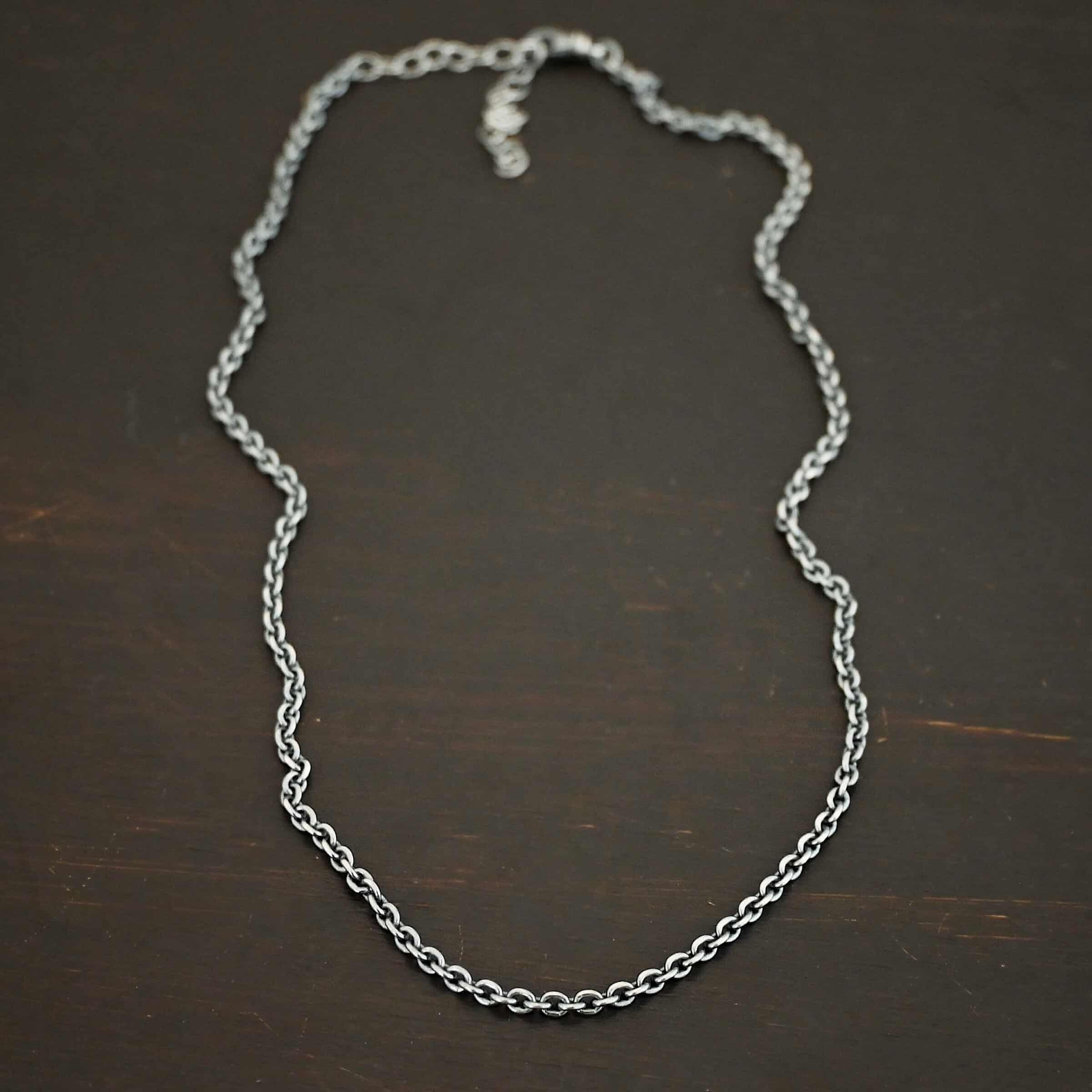 Maria Chain Oxidized sterling silver Maria chain with circle links that is laying on a dark background. Links are 4x3mmx.8mm thick.