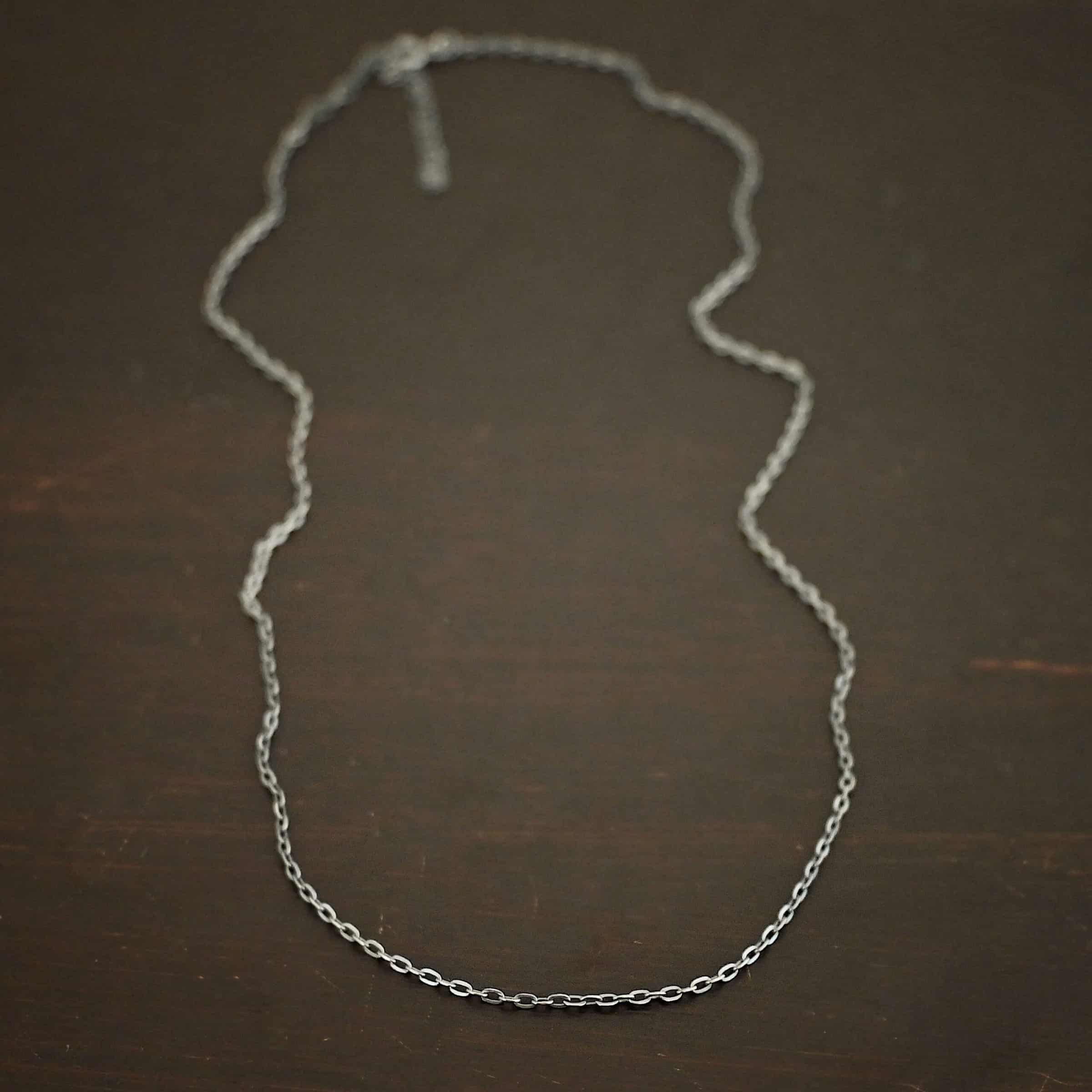 Cassandra Chain "Cassandra" Chain as shown lying against a dark background. Chain is shown as oxidized. Chain has 2x2mm links.
