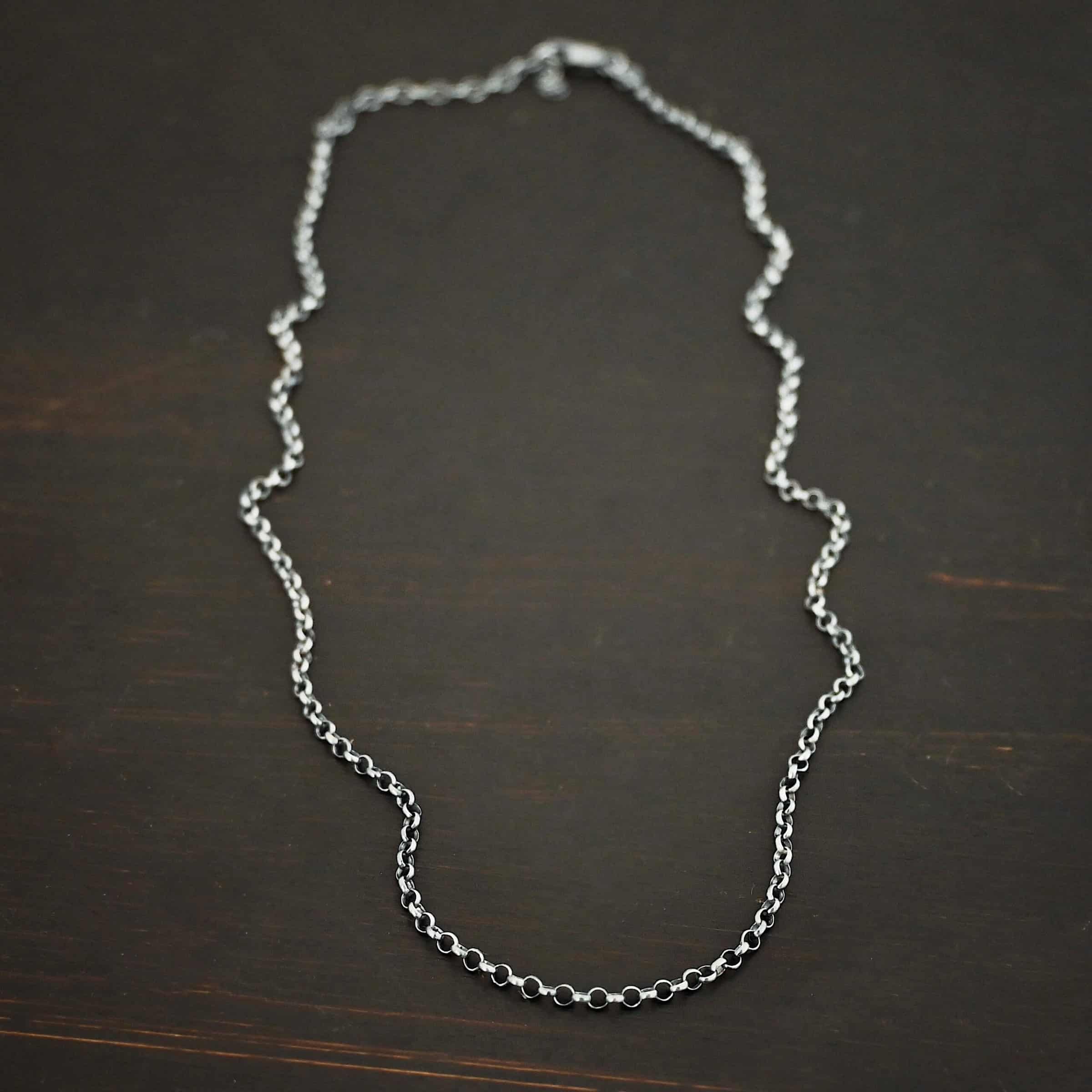 "Rachel Rolo" Chain as oxidized. Made out of sterling silver and comes with the 3 inch chain extension. Chain is made out of small, but thick circles. Chain has a lobster claw clasp.