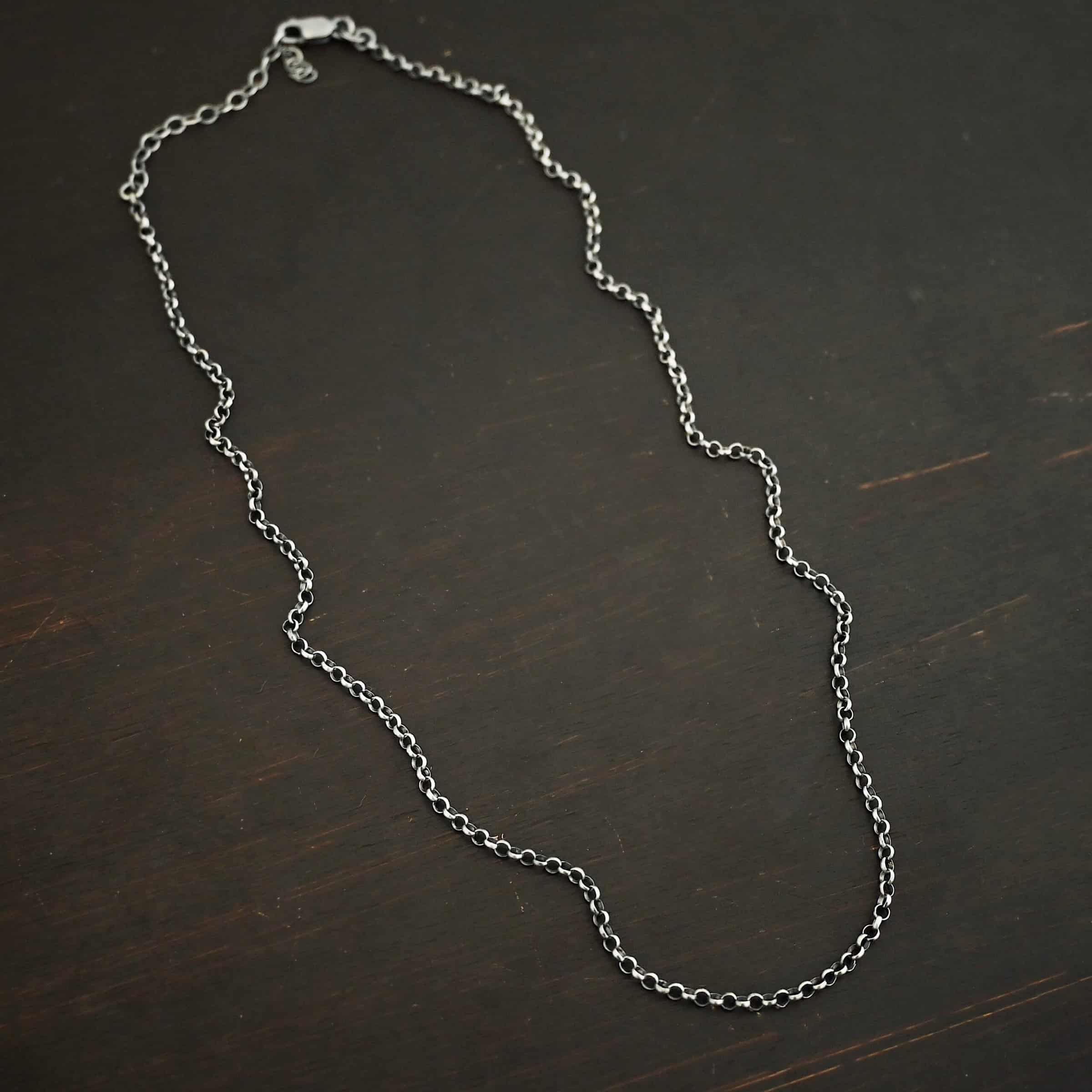 "Rachel Rolo" Chain as oxidized. Made out of sterling silver and comes with the 3 inch chain extension. Chain is made out of small, but thick circles. Chain has a lobster claw clasp.