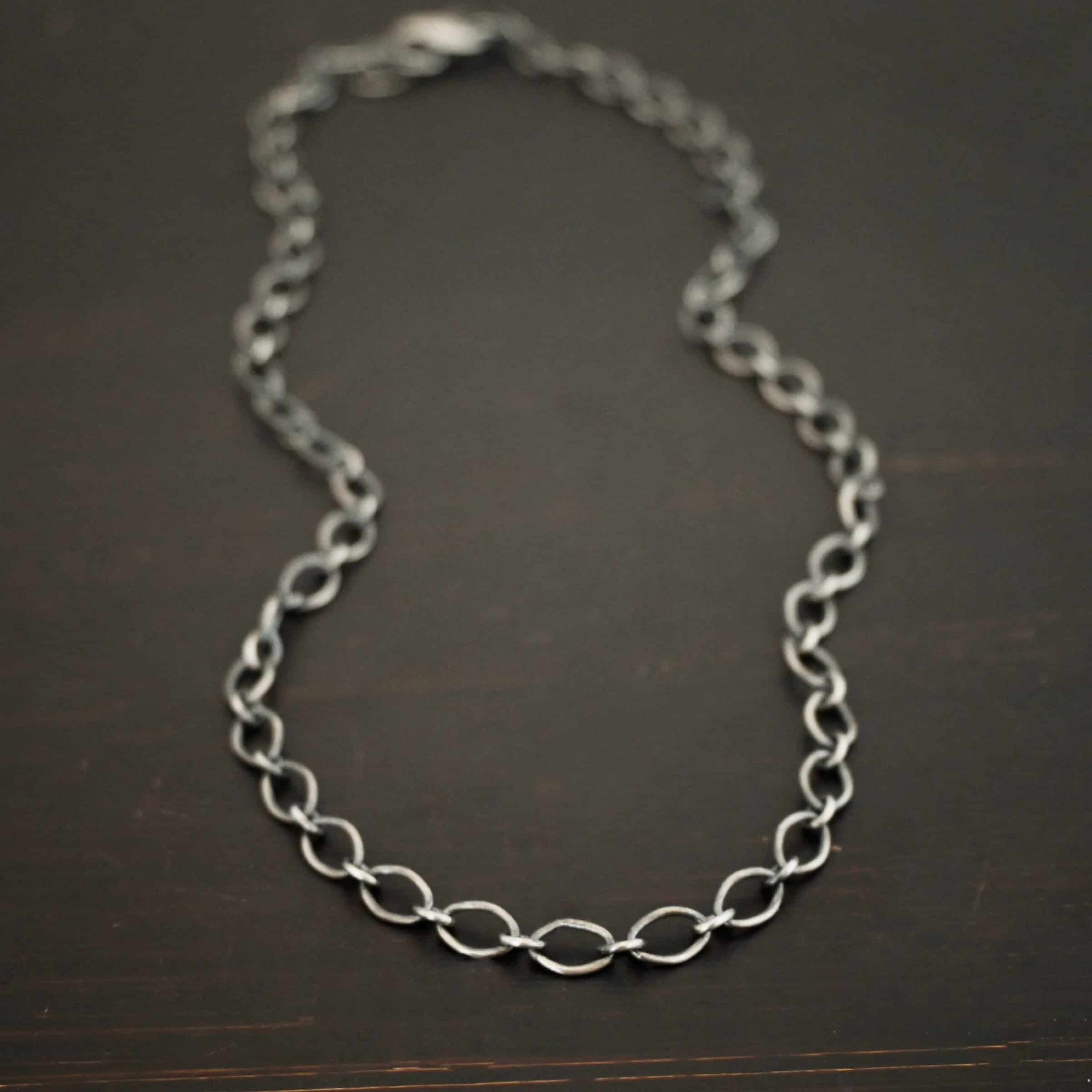Allie Chain Sterling silver oxidized Allie oval chain shown on dark background. Oval links measure 7×4.6mm.
