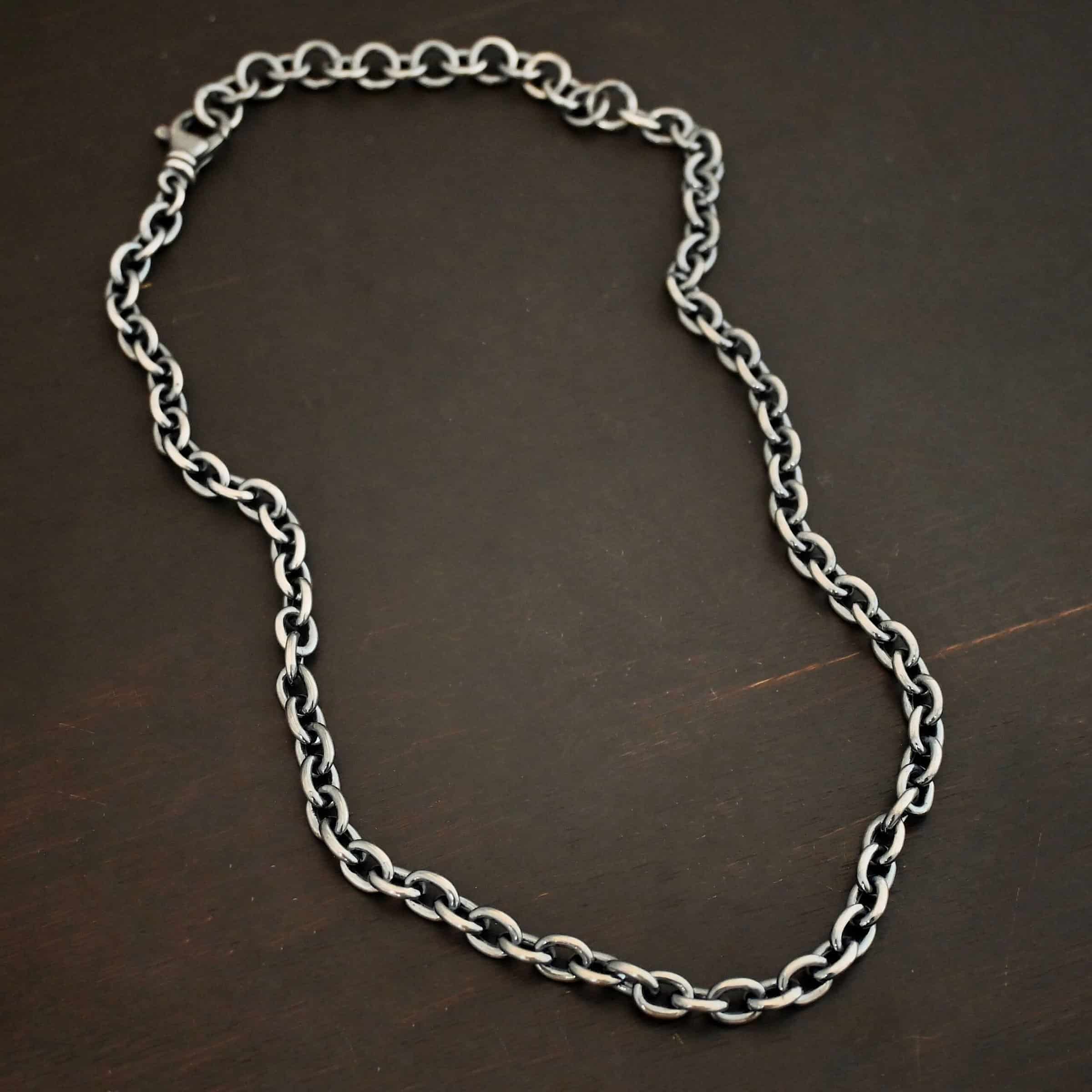 Oxidized sterling silver Georgia Chain with thick oval links that measure 8x6mmx1.7mm thick. Chain is resting against a dark background.