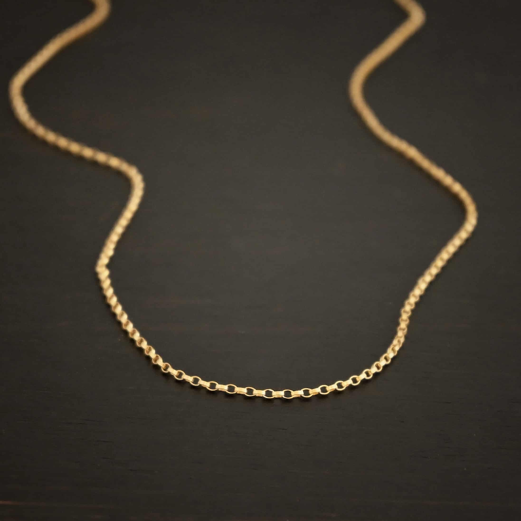 Close up of the "Jessica Rolo" Chain as shown against a dark background. Chain is 1.2mm thick and 14K Gold Filled over sterling silver.