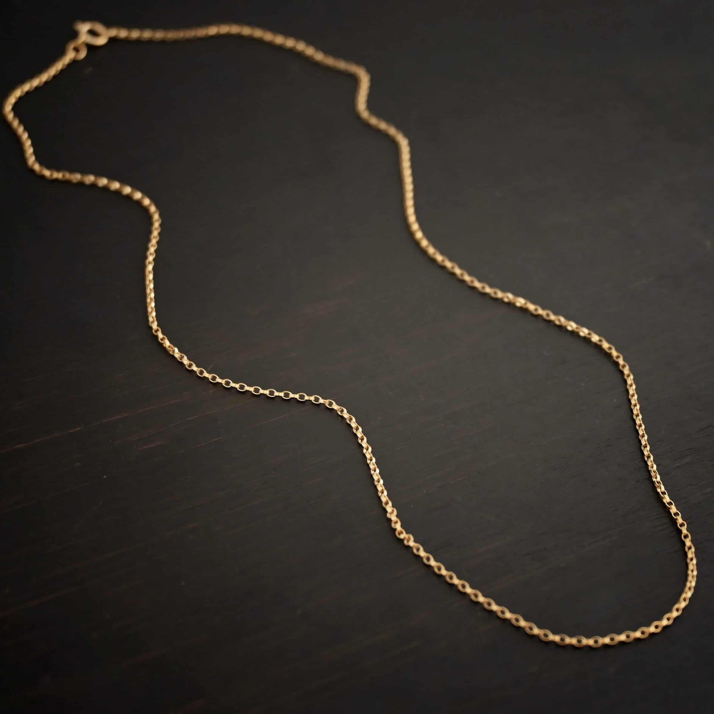 Close up of the "Jessica Rolo" Chain as shown against a dark background. Chain is 1.2mm thick and 14K Gold Filled over sterling silver.
