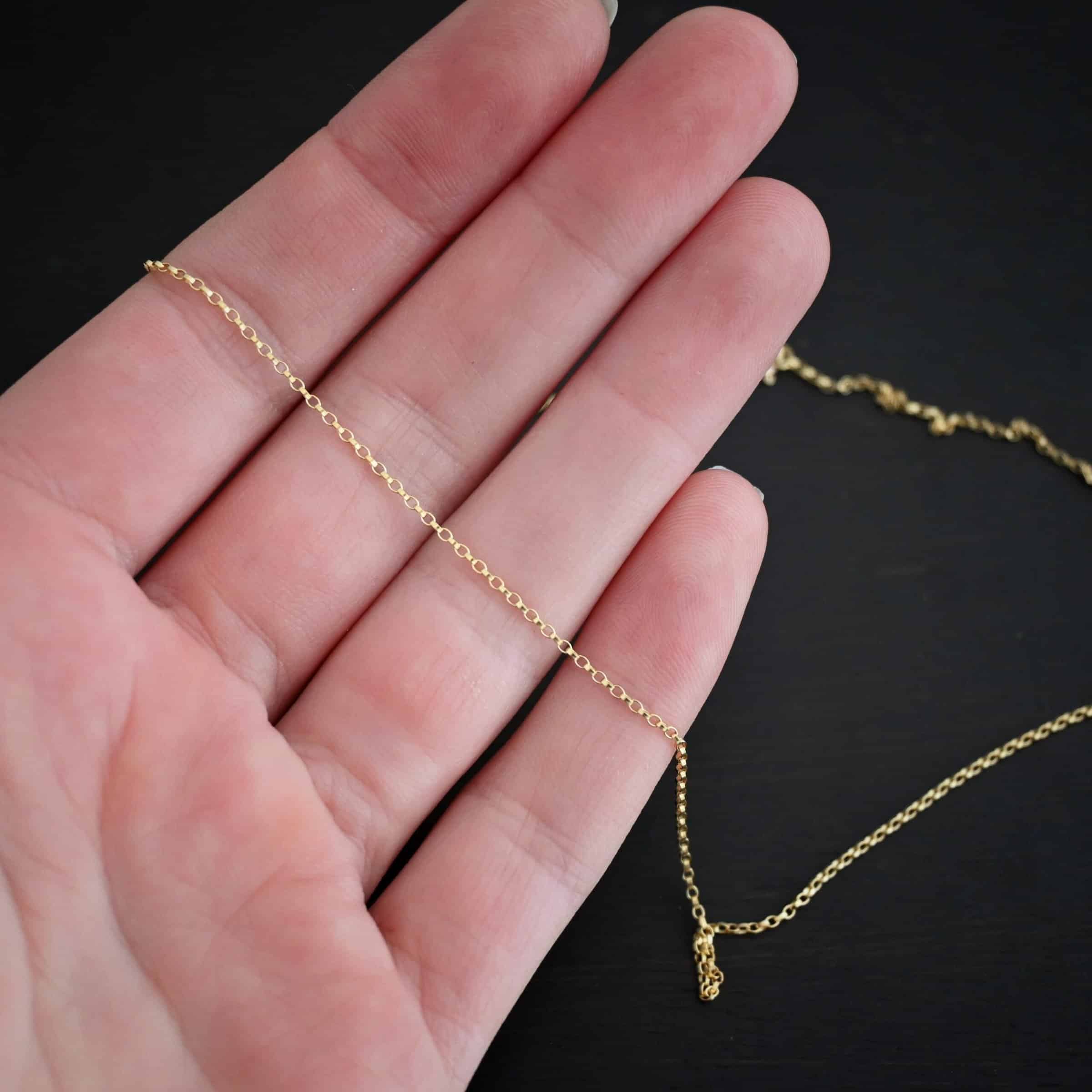 Close up of the "Jessica Rolo" Chain as shown against the fingertips of a hand. Chain is 1.2mm thick and 14K Gold Filled over sterling silver.