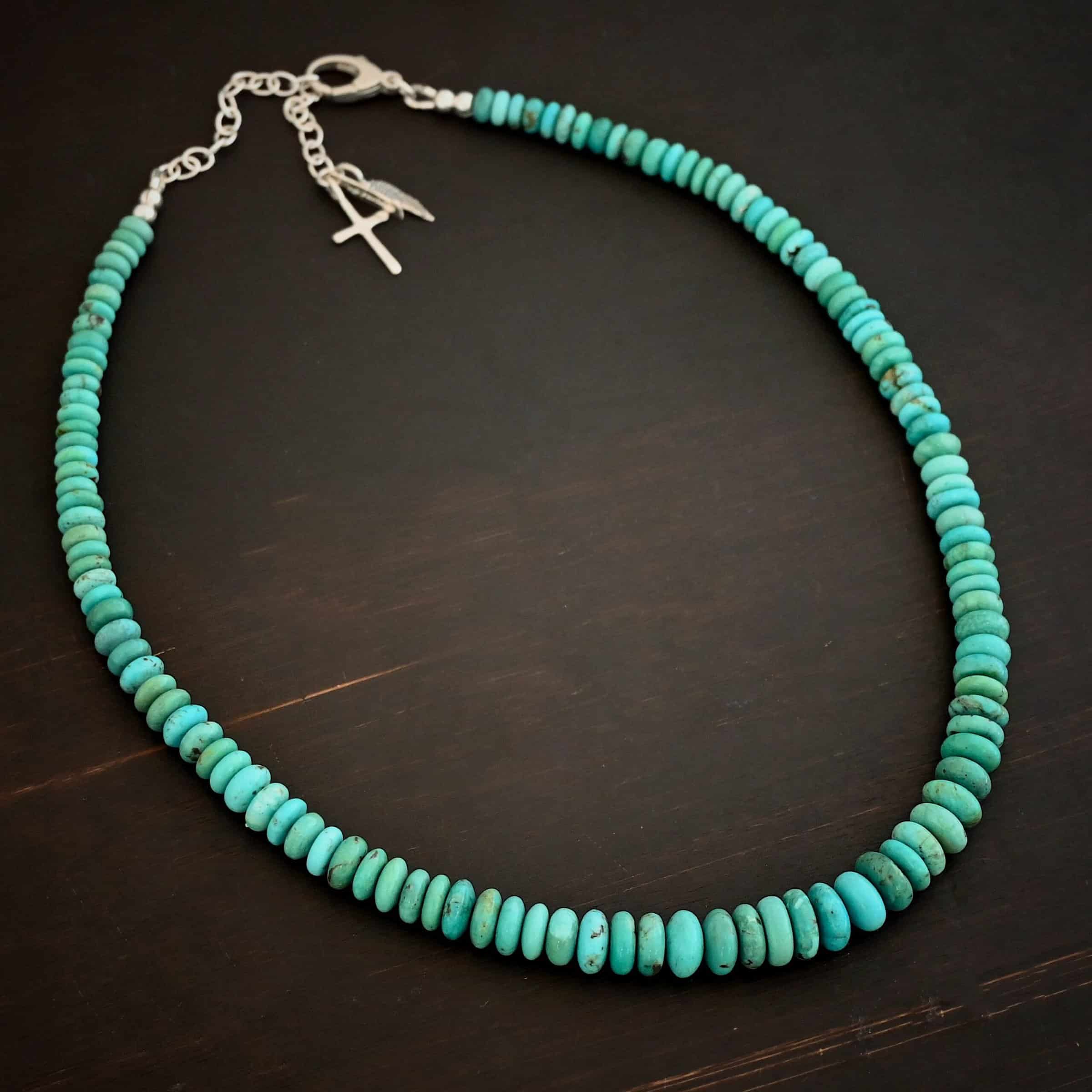 Bonnie Small Photo of the "Bonnie" Necklace. Made out of sterling silver and turquoise. Beads are varying shades of blueish green colors. The beads graduate in size slightly as they get towards the center. Beads are strung tightly together. Necklace is lying against a dark background.