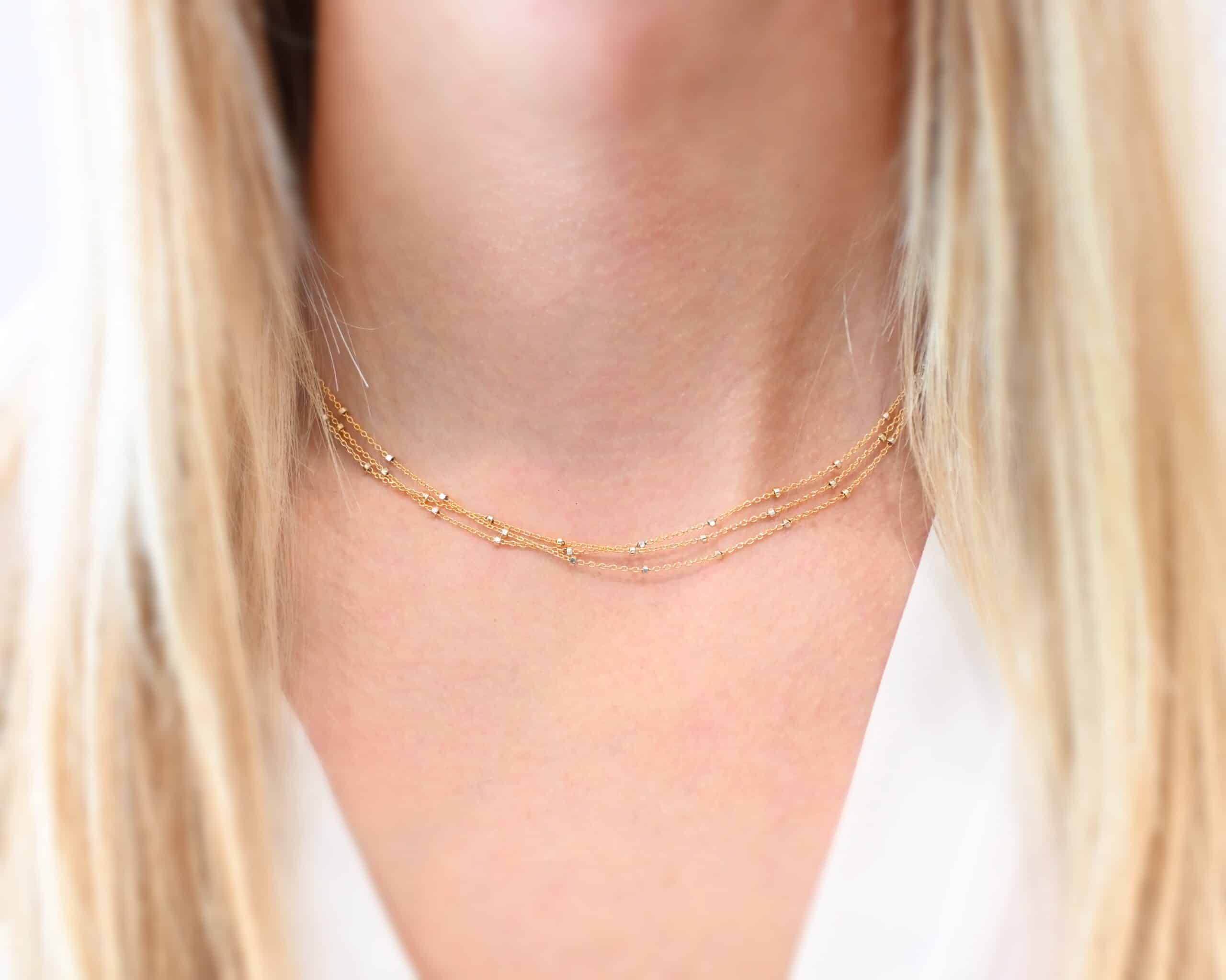 Morning in Paris Chain "Morning In Paris" Chain as shown up close. Gold Filled over Sterling Silver chain that is 1.2mm thick with 1.5mm beads. Chain is three separate strands that meet together at the back to make one chain. Chain is shown worn by a model at 15" long to demonstrate size.