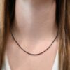 "Frenchie" Chain as shown up close and on a model. Chain is shown at 18 inches and with an oxidized finish. Model is wearing a white v-neck shirt.