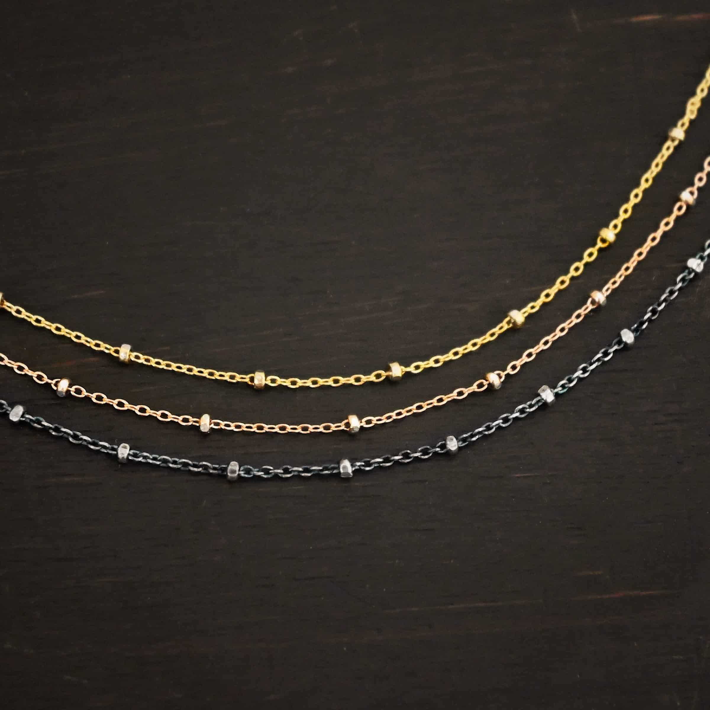 Champagne in Paris ox "Champagne In Paris" Chain as shown up close. oxidized Sterling Silver, 14K Rose Gold Filled, & 14K Yellow Gold Filled chain 1.2mm thick. Chain is shown against a dark background.