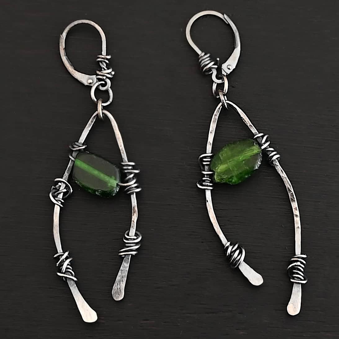 "Forest Glen" Earrings. There is an upside down "U" shape with silver wire wrapped around each side. There is a chrome diopside bead in between the "U" shape for each earring.