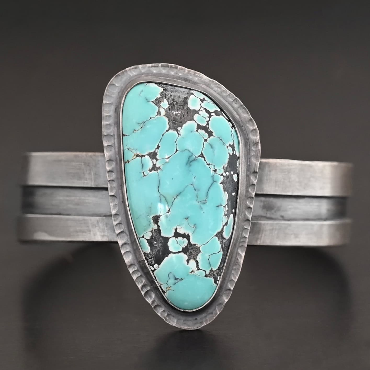 Mountains Are Calling Cuff New "Mountains Are Calling" Cuff. There is a large, oval shaped turquoise in the center with hammered sterling silver around the stone. The band of the cuff is thick and oxidized. The entire center of the cuff has a thick rectangular line that is cut out and oxidized deeper than the rest of the cuff.