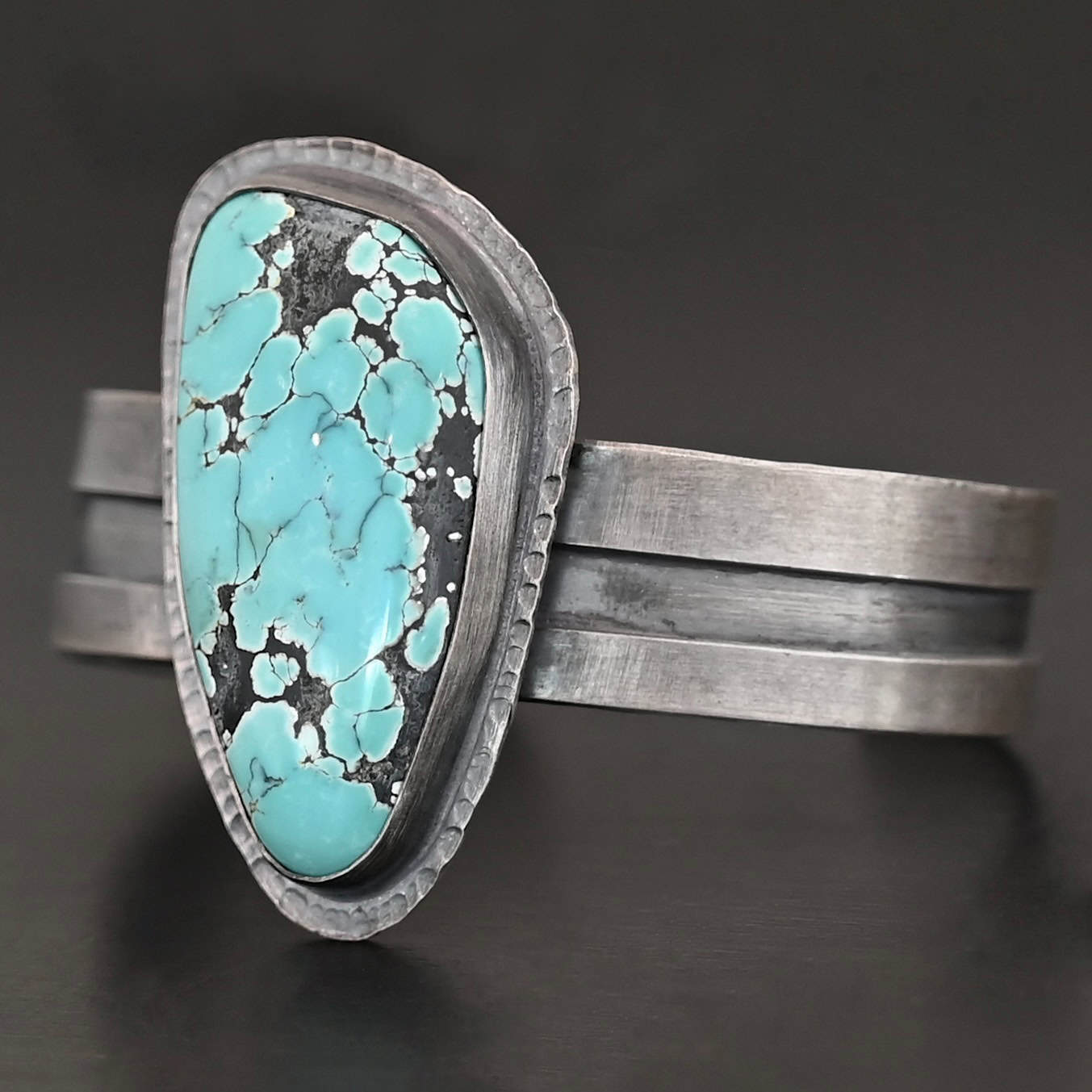 Mountains Are Calling Cuff New "Mountains Are Calling" Cuff. There is a large, oval shaped turquoise in the center with hammered sterling silver around the stone. The band of the cuff is thick and oxidized. The entire center of the cuff has a thick rectangular line that is cut out and oxidized deeper than the rest of the cuff.