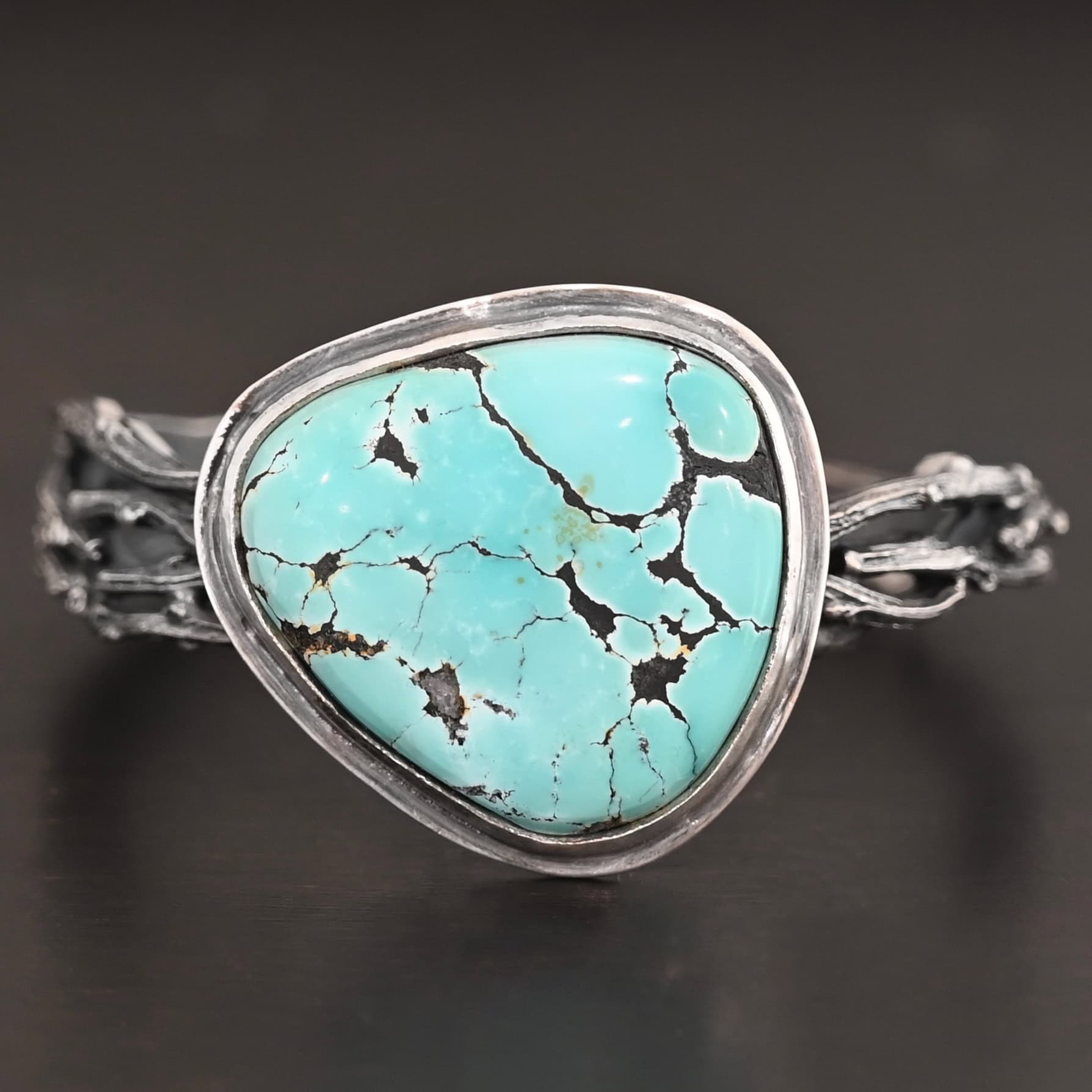 Under The Big Sky Cuff New "Under The Big Sky" Cuff. There is a very large, mostly circular turquoise in the center of a thick cuff. The cuff is multiple casted sterling silver twigs that are soldered together and create a cuff.