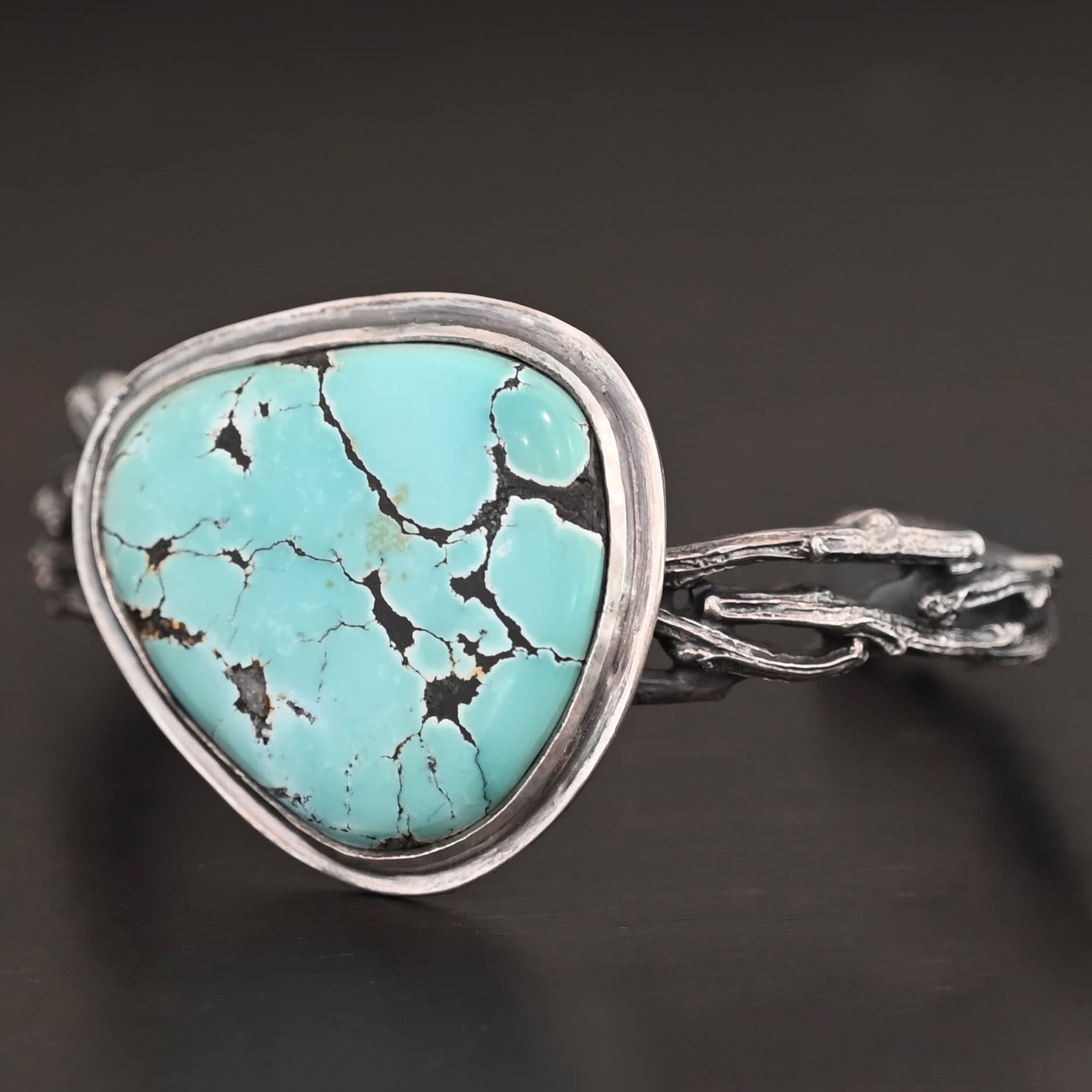 Under The Big Sky Cuff New "Under The Big Sky" Cuff. There is a very large, mostly circular turquoise in the center of a thick cuff. The cuff is multiple casted sterling silver twigs that are soldered together and create a cuff.
