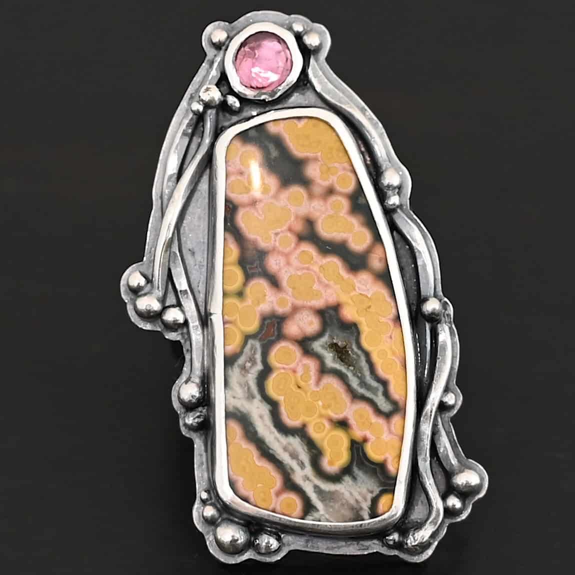 Yellow Rose Of Texas Ring "Yellow Rose Of Texas" Ring. There is a rectangular ocean jasper, set vertically. There is a smaller circular pink tourmaline above it. There are lots of wavy, hammered lines of silver around the stones.