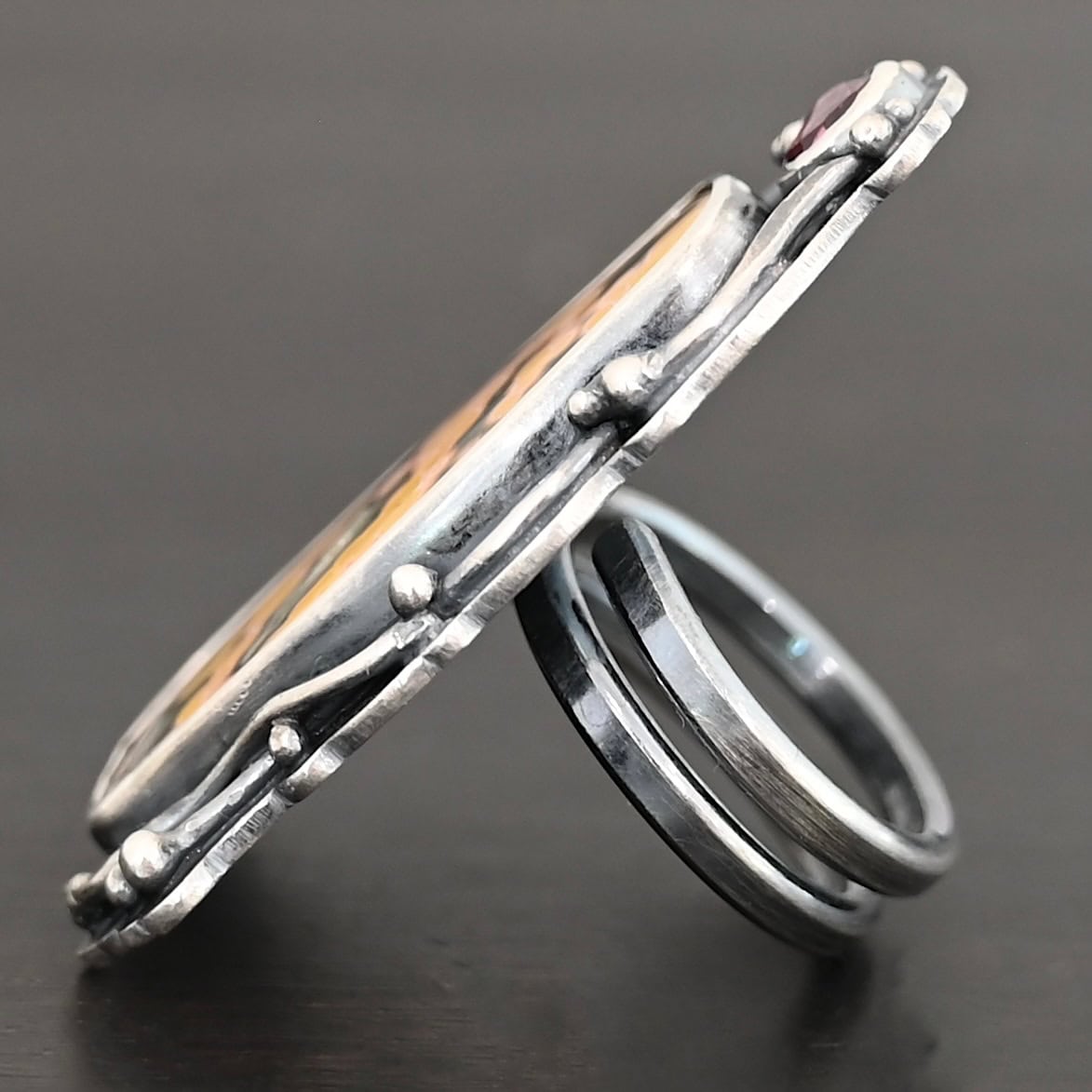 Yellow Rose Of Texas Ring "Yellow Rose Of Texas" Ring. There is a rectangular ocean jasper, set vertically. There is a smaller circular pink tourmaline above it. There are lots of wavy, hammered lines of silver around the stones. Ring is double banded so it can be adjusted.