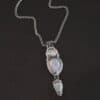 "Blue Moon Magic" Necklace. There are three opals in a line down. The top one is a small horizontal oval. The next one is a larger, vertical opal. The bottom one is a small triangle. Each one has silver ball detail surrounding it, as well as hammered silver.
