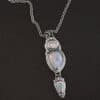 "Blue Moon Magic" Necklace. There are three opals in a line down. The top one is a small horizontal oval. The next one is a larger, vertical opal. The bottom one is a small triangle. Each one has silver ball detail surrounding it, as well as hammered silver.