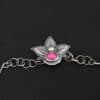 "In The Dawns" Necklace Clasp. The clasp of the necklace has three silver leaves and a ball of silver above an oval ruby. Chain is handmade out of wavy links of sterling silver.