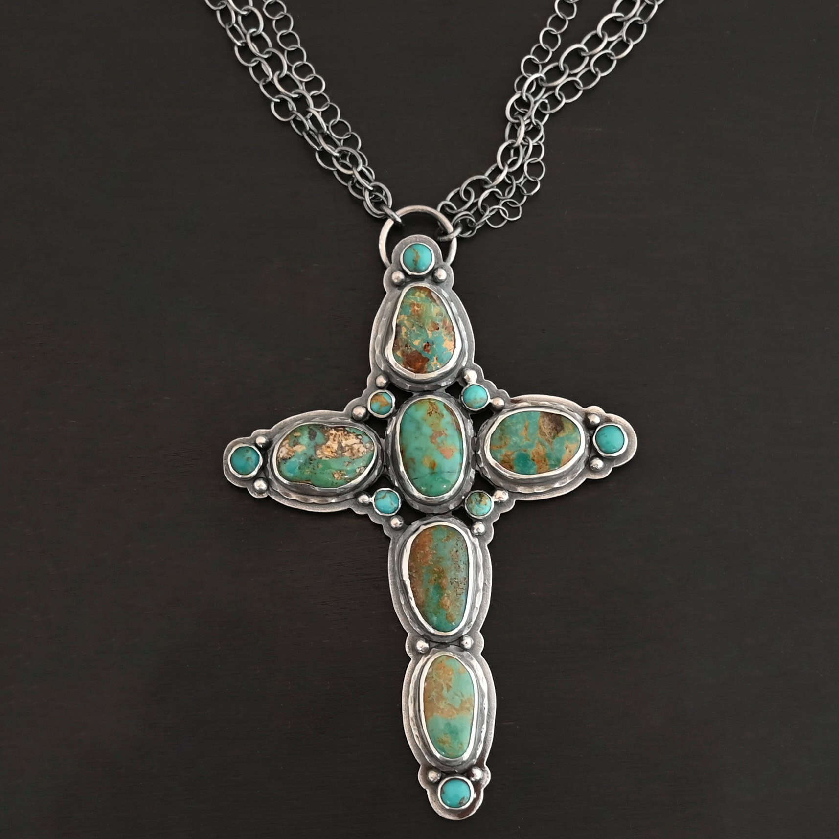 Firm In Faith Necklace "Firm In Faith" Necklace. Necklace is a large cross shape with six oval turquoise creating the cross shape eight small circular turquoise around the rest of the pendant. Chain is multiple strands that meet at the back.