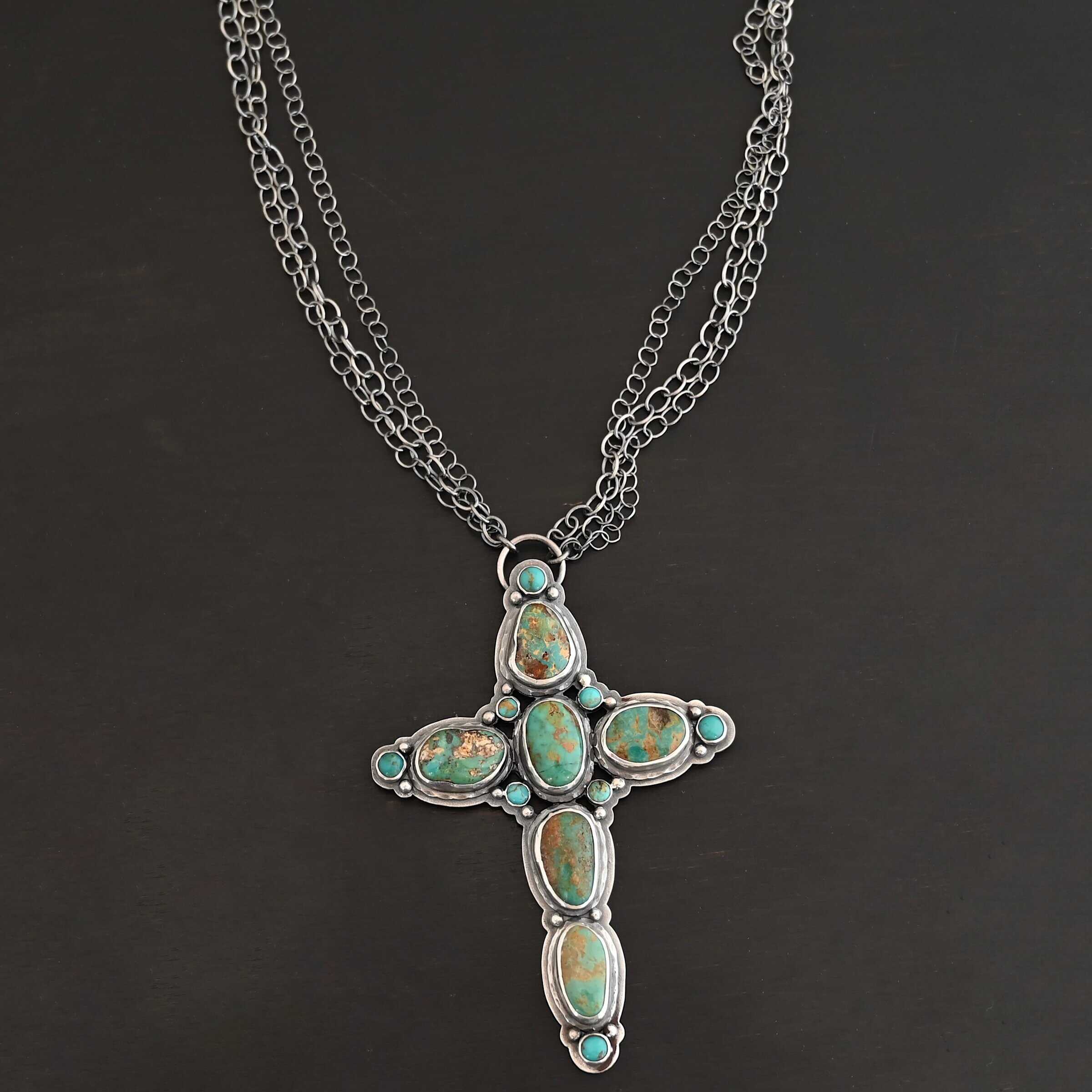 Firm In Faith Necklace "Firm In Faith" Necklace. Necklace is a large cross shape with six oval turquoise creating the cross shape and eight small circular turquoise around the rest of the pendant. Chain is multiple strands that meet at the back.