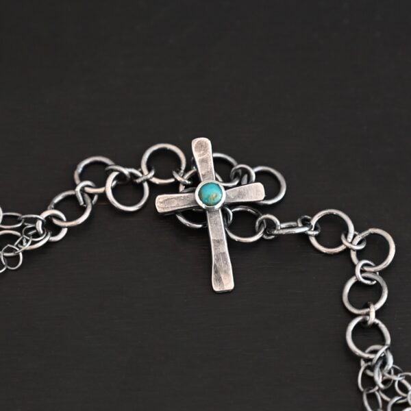 "Firm In Faith" Necklace Clasp. Necklace has a small silver cross with a turquoise in the center of it for the clasp.