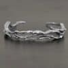 "Forests And Groves" Cuff. The cuff is casted sterling silver branches from a tree that are curved.