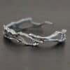 "Forests And Groves" Cuff. The cuff is casted sterling silver branches from a tree that are curved.
