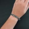 "Forests And Groves" Cuff. The cuff is casted sterling silver branches from a tree that are curved. Cuff is worn up close by a model.