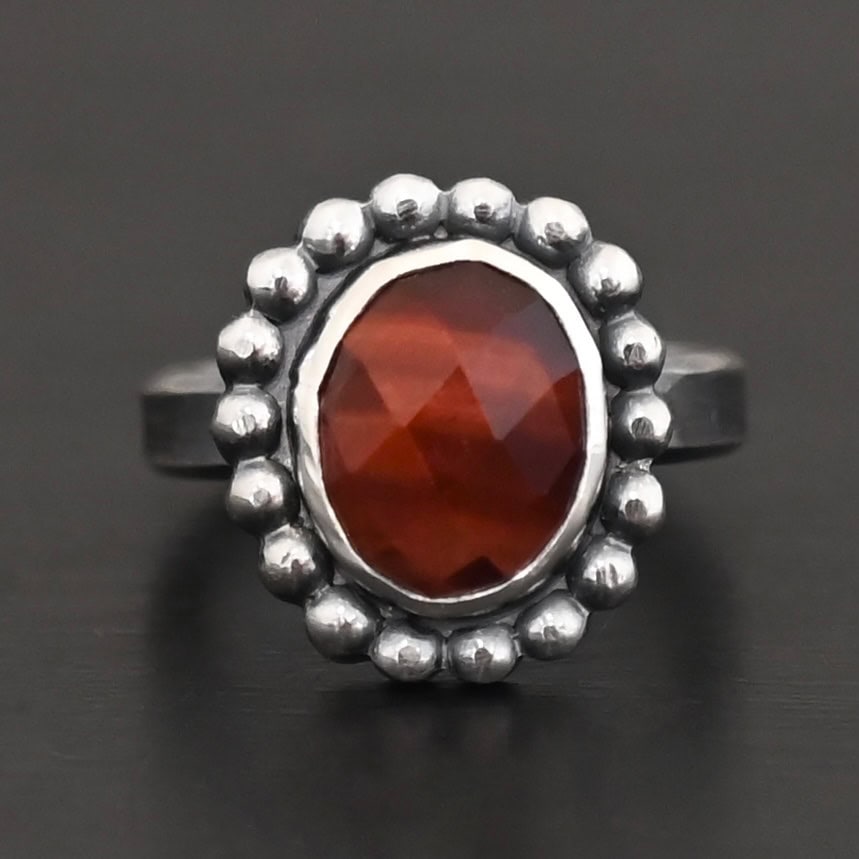 Walk Through Fire Ring "Walk Through Fire" Ring. Sterling Silver & Pietercite. There is an oval, vertical pietercite in the center with balls of silver circling all the way around it. Ring band is smooth & lightly oxidized.