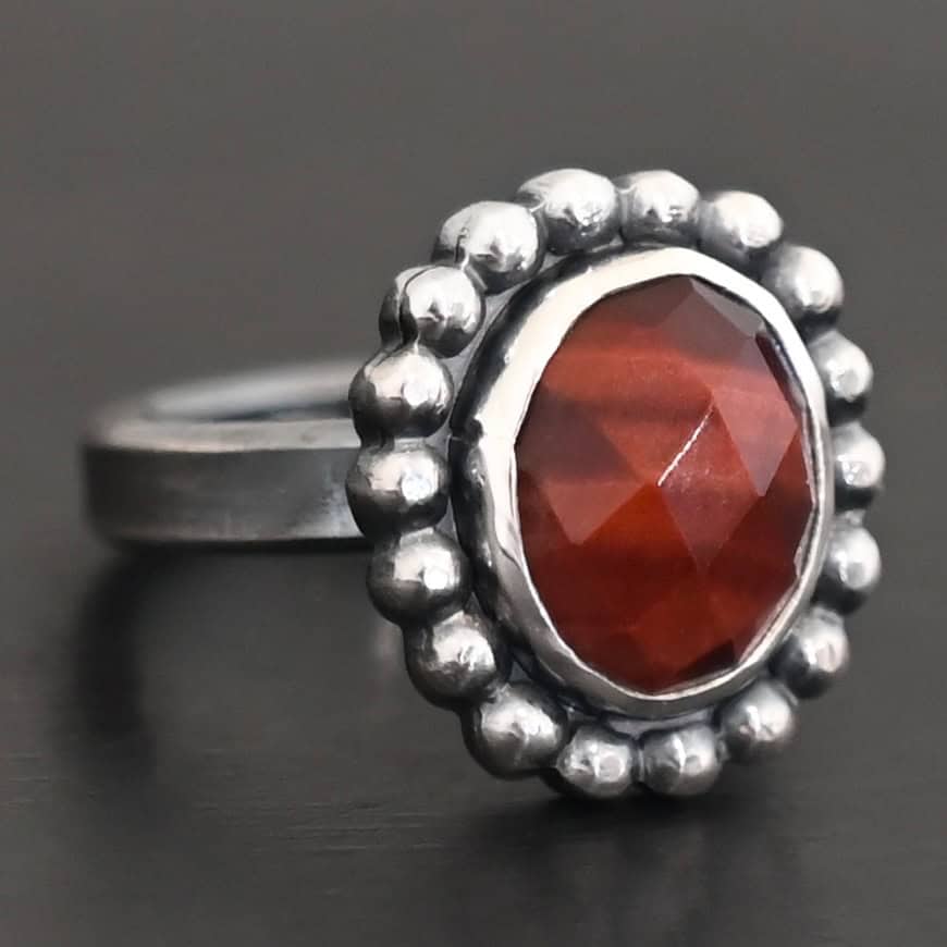 Walk Through Fire Ring "Walk Through Fire" Ring. Sterling Silver & Pietercite. There is an oval, vertical pietercite in the center with balls of silver circling all the way around it. Ring band is smooth & lightly oxidized.