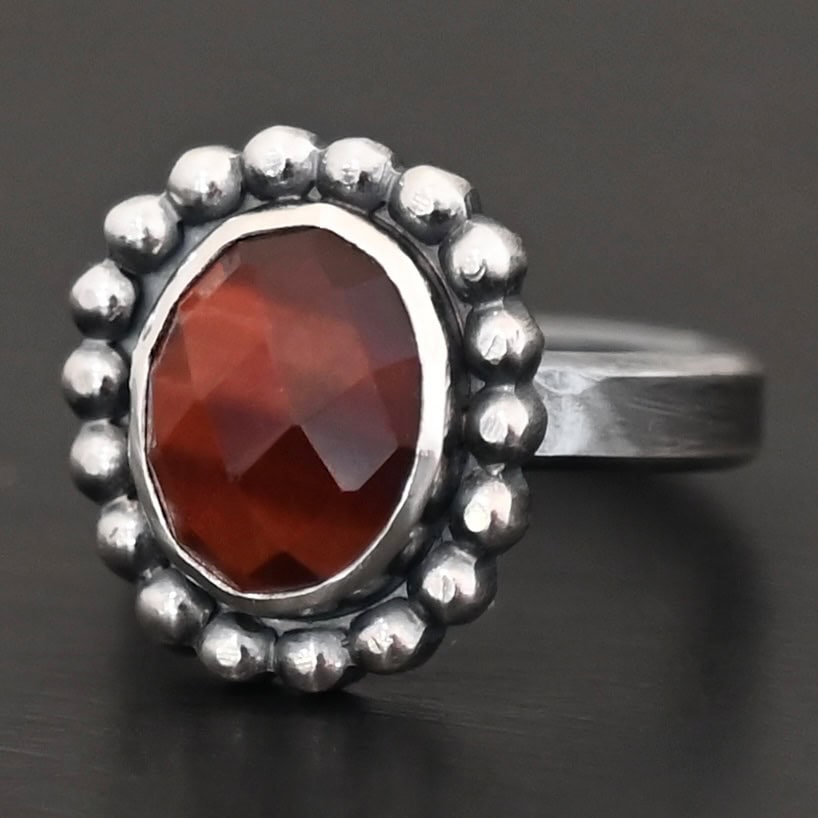 Walk Through Fire Ring "Walk Through Fire" Ring. Sterling Silver & Pietercite. There is an oval, vertical pietercite in the center with balls of silver circling all the way around it. Ring band is smooth & lightly oxidized.