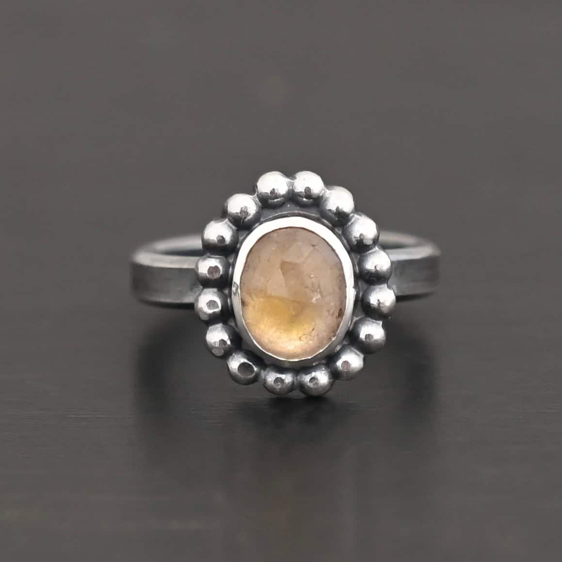 Radiant Sun Ring "Radiant Sun" Ring. Sterling Silver & Citrine. There is an oval, vertical citrine in the center with balls of silver circling all the way around it. Ring band is smooth & lightly oxidized.