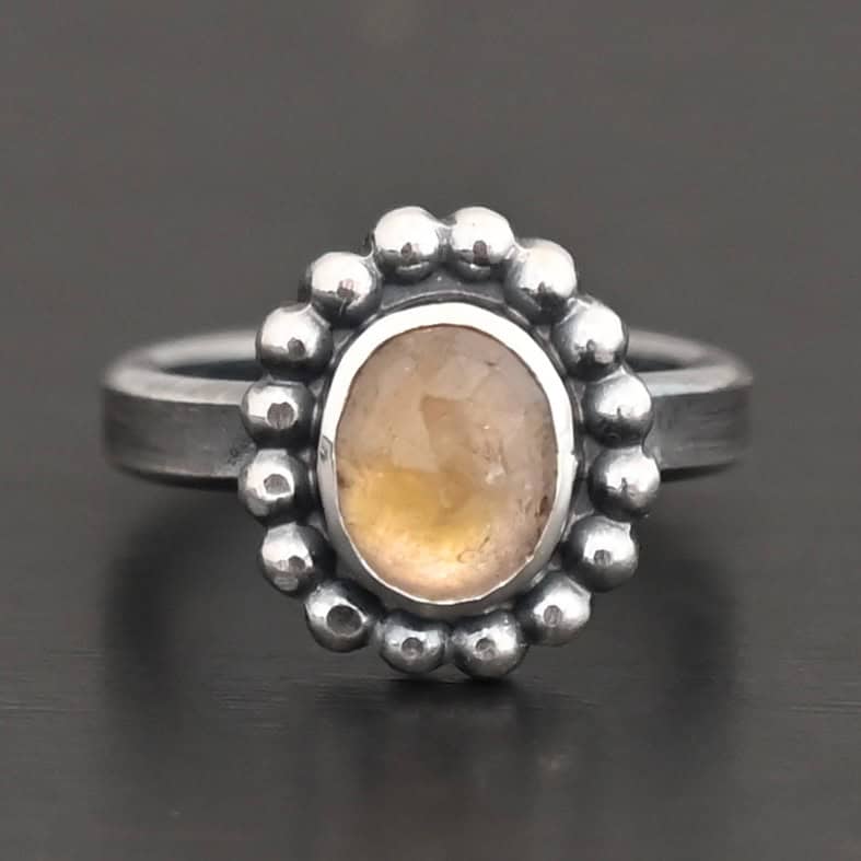 Radiant Sun Ring "Radiant Sun" Ring. Sterling Silver & Citrine. There is an oval, vertical citrine in the center with balls of silver circling all the way around it. Ring band is smooth & lightly oxidized.