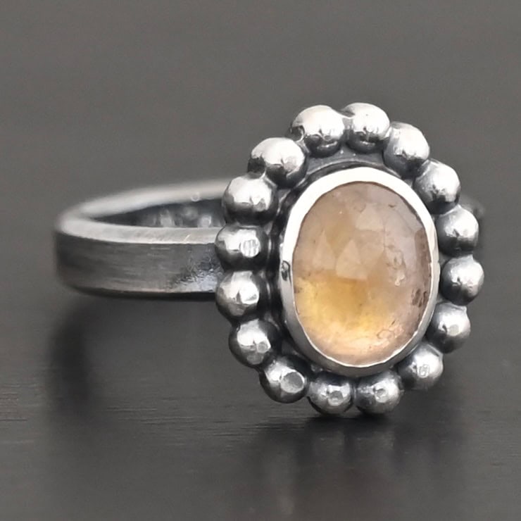 Radiant Sun Ring "Radiant Sun" Ring. Sterling Silver & Citrine. There is an oval, vertical citrine in the center with balls of silver circling all the way around it. Ring band is smooth & lightly oxidized.