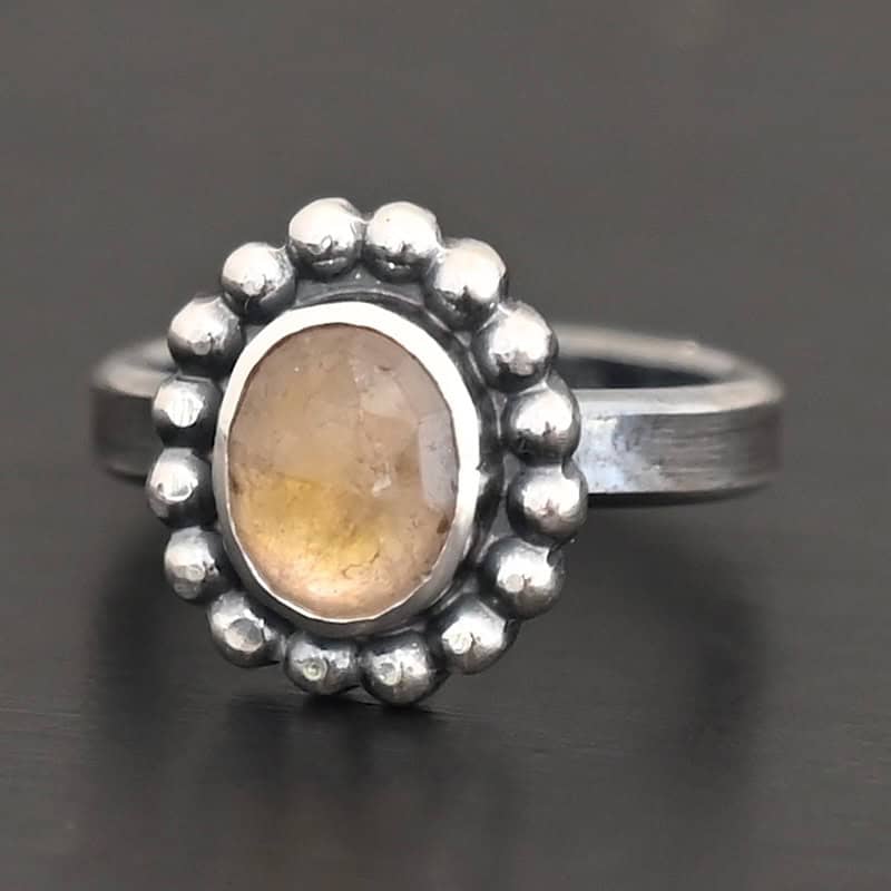 Radiant Sun Ring "Radiant Sun" Ring. Sterling Silver & Citrine. There is an oval, vertical citrine in the center with balls of silver circling all the way around it. Ring band is smooth & lightly oxidized.