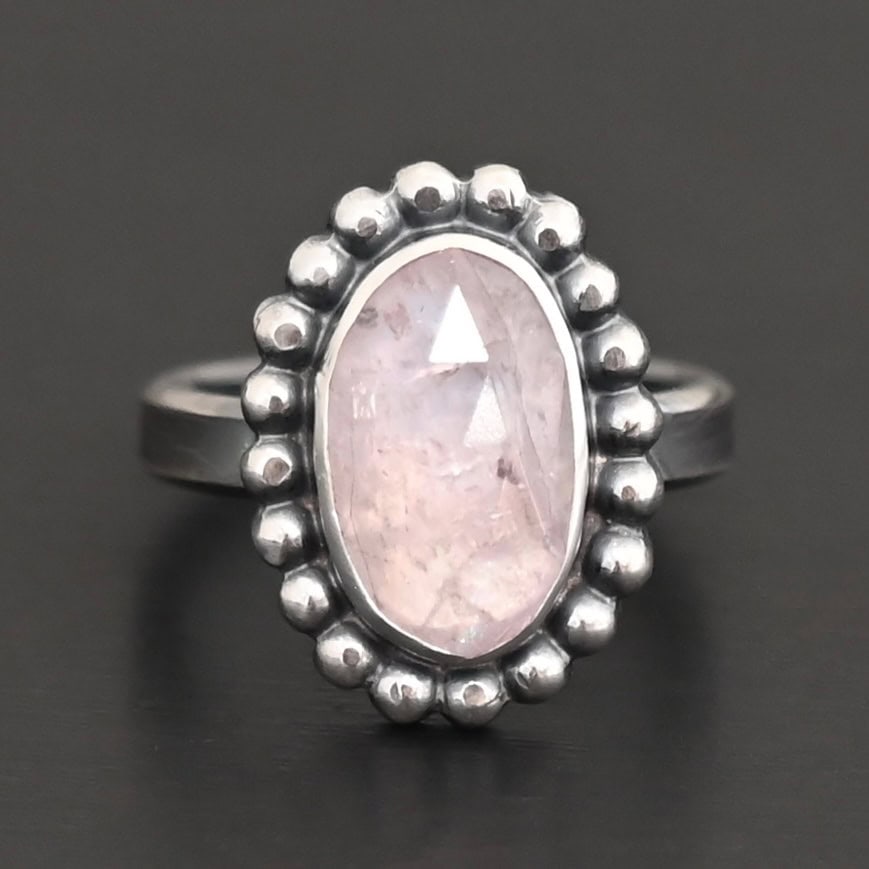 Calliope Ring "Calliope" Ring. Sterling Silver & Morganite. There is an oval, vertical morganite in the center with balls of silver circling all the way around it. Ring band is smooth & lightly oxidized.
