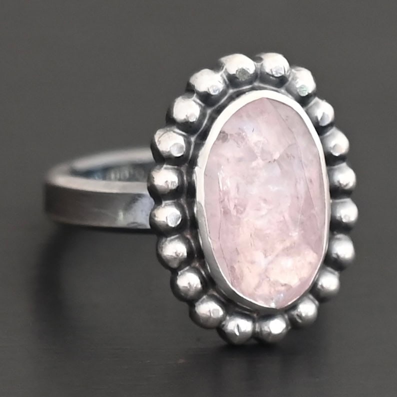 Calliope Ring "Calliope" Ring. Sterling Silver & Morganite. There is an oval, vertical morganite in the center with balls of silver circling all the way around it. Ring band is smooth & lightly oxidized.