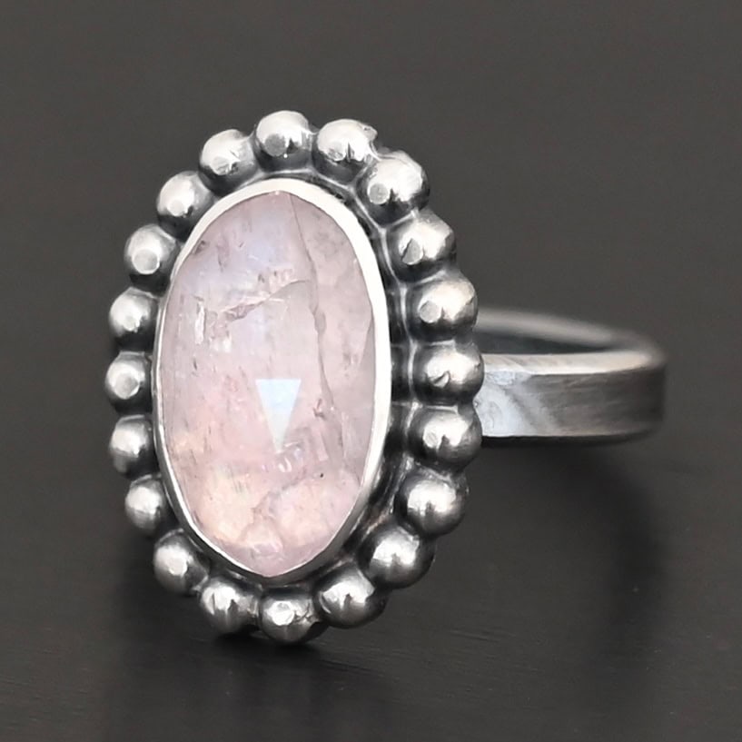 Calliope Ring "Calliope" Ring. Sterling Silver & Morganite. There is an oval, vertical morganite in the center with balls of silver circling all the way around it. Ring band is smooth & lightly oxidized.