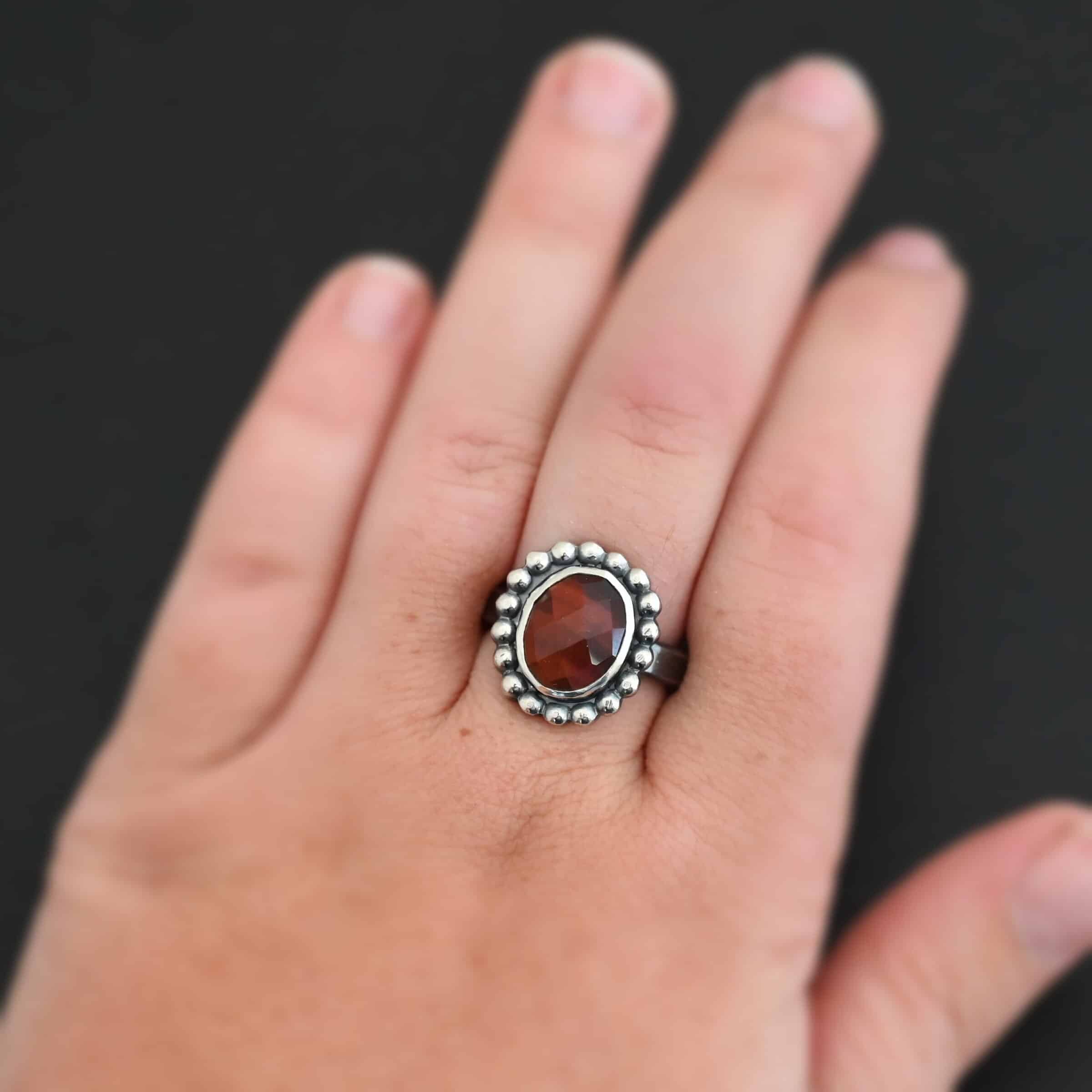 Walk Through Fire Ring "Walk Through Fire" Ring. Sterling Silver & Pietercite. There is an oval, vertical pietercite in the center with balls of silver circling all the way around it. Ring band is smooth & lightly oxidized.